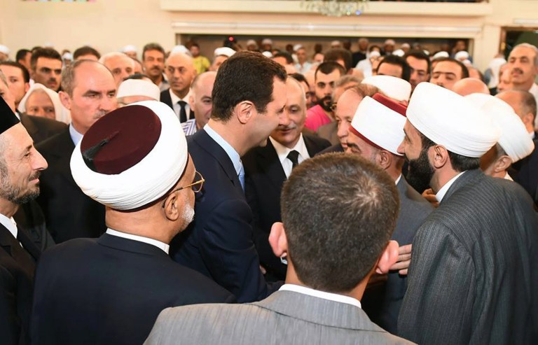 In this photo released by the Syrian official news agency SANA, Syrian President Bashar Assad, center, shakes hands with worshippers on the first day of Eid al-Fitr marking the end of the Muslim fasting month of Ramadan at the Khair mosque, in Damascus, Syria, Monday, July 28, 2014. (AP Photo/SANA)