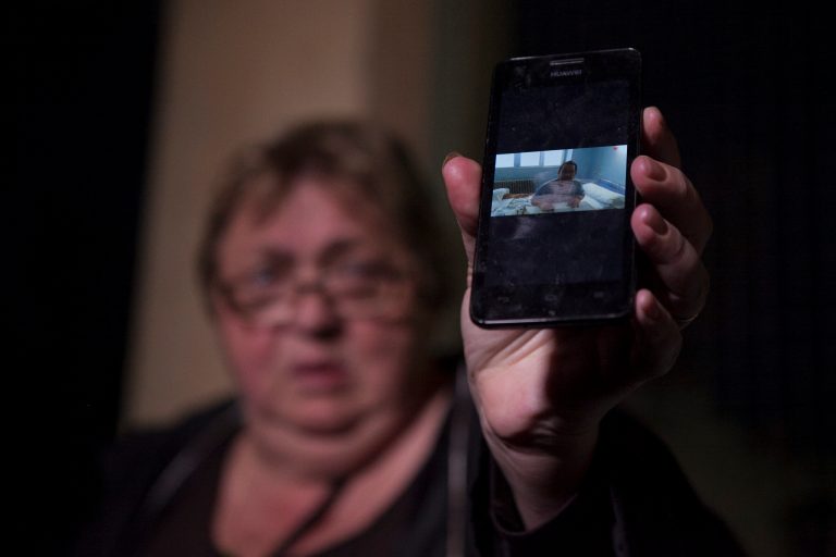Teresa Mesa, spokesperson of Ebola patient Teresa Romero, shows to the media a video of Romero's husband, who is in quarantine, in front of the Carlos III Hospital in Madrid, Spain, Sunday, Oct. 19, 2014. Spain says a test has shown a nursing assistant who became infected with Ebola is now clear of all traces of the virus. A blood test has revealed that Teresa Romero's immune system has eliminated the virus from her body, according to a statement released by Prime Minister Mariano Rajoy's office late Sunday. Romero, 44, had treated two patients who died of Ebola at Carlos III hospital. The first, Miguel Pajares, contracted the disease in Liberia and died on Aug. 12 despite having been treated with the experimental drug ZMapp. The second was Manuel Garcia Viejo who died, aged 69, on Sept. 25. (AP Photo/Gabriel Pecot)
