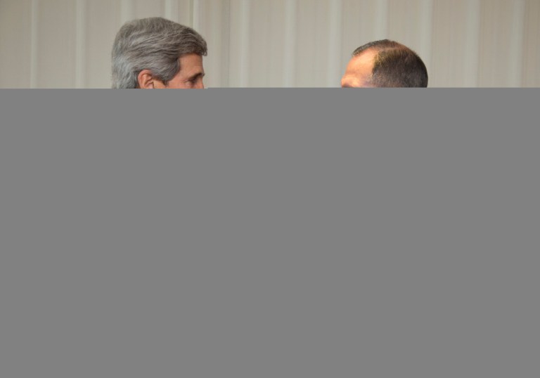 U.S. Secretary of State John Kerry, left, and Russia's Foreign Minister Sergei Lavrov shake hands prior to their meeting in Geneva, Switzerland, on Saturday. (AP Photo/Carolyn Kaster, Pool)