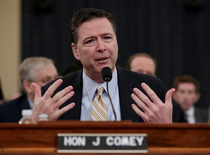 FBI Director James Comey gestures while speaking.