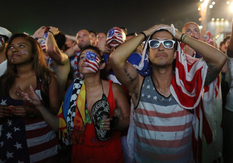 Fans of the United States national soccer team react, in frustration, as they watch their team's World Cup round of 16 match against Belgium on a live telecast inside the FIFA Fan Fest area on Copacabana beach in Rio de Janeiro, Brazil, Tuesday, July 1, 2014. Belgium beat the United States 2-1 in extra time to reach World Cup quarterfinals. (AP Photo/Leo Correa)