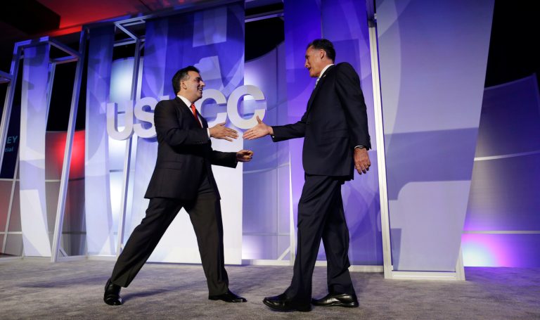 Republican presidential candidate Mitt Romney is greeted by Hector Barreto, chairman of the Latino Coalition, before he addresses the U.S. Hispanic Chamber of Commerce in Los Angeles on Monday. (AP Photo)