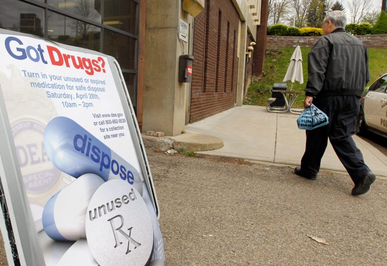 A man carries a bag of medications to dispose of at the Allegheny County police station in North Park on Saturday, April 28, 2012, in Allison Park, Pa. (AP Photo/Keith Srakocic)