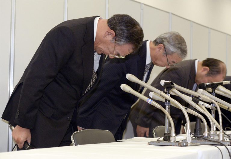 In this Saturday, Jan. 25, 2014 photo, Maruha Nichiro Holdings Inc. President Toshio Kushiro, left, and subsidiary Aqli Foods President Yutaka Tanabe, second from left, bow in apology during a press conference in Tokyo. A factory worker at the plant that had churned out food laced with pesticide has been arrested Saturday as a suspect in the massive poisoning that prompted a recall of more than 6 million packages of frozen food. Maruha Nichiro announced executive pay cuts and said that presidents were resigning in March to take responsibility for the food-poisoning. (AP Photo/Kyodo News) JAPAN OUT, NO SALES