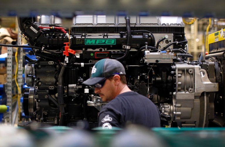 In this March 26, 2014 picture, Ed Carbaugh prepares to install parts on a truck engine on an assembly line at Volvo Trucks' powertrain manufacturing facility in Hagerstown, Md. The Federal Reserve reports on industrial production for April on Thursday, May 15, 2014. (AP Photo/Patrick Semansky)