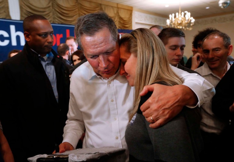 John Kasich has taken to embracing audience members he thinks could use a hug. (AP Photo/Paul Sancya)