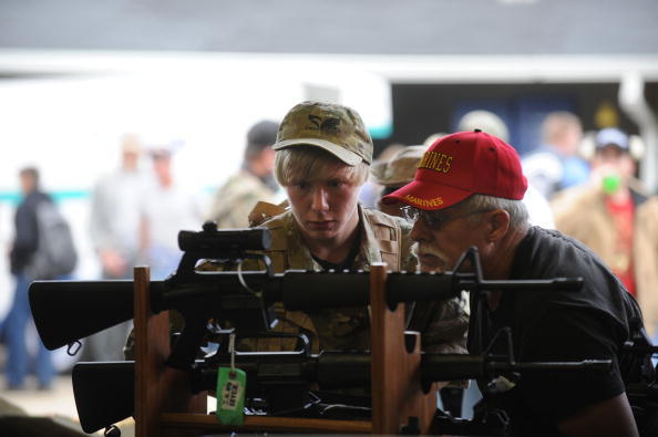 People look at machine guns at the Knob Creek Machine Gun Shoot. (Getty Images)