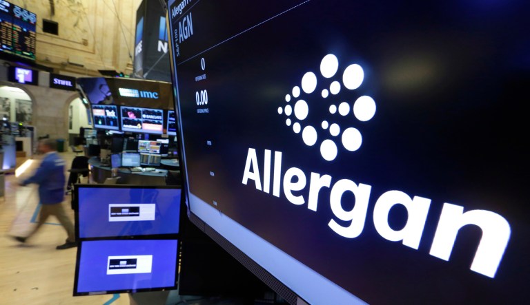 FILE - In this Monday, Nov. 23, 2015, file photo, the Allergan logo appears above a trading post on the floor of the New York Stock Exchange. (AP Photo/Richard Drew, File)