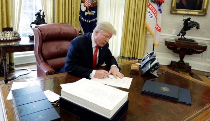 President Trump signed the bill ending the partial government shutdown Monday night, after both houses in Congress approved the bill earlier in the day. (AP Photo/Evan Vucci)
