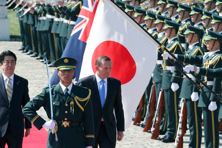 Australian Prime Minister Tony Abbott, center, reviews an honor guard during a welcome ceremony with Japanese Prime Minister Shinzo Abe, left, at Akasaka State Guest House in Tokyo  Monday, April 7, 2014.  Abbott is on a four-day official visit. (AP Photo/Koji Sasahara)