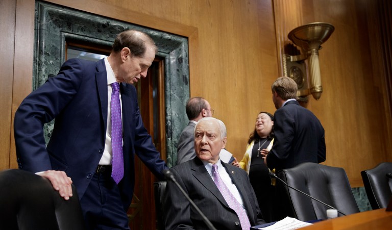 Senate Finance Committee Chairman Sen. Orrin Hatch, R-Utah, seated, talks with the committee's ranking member Sen. Ron Wyden, D-Ore. on Capitol Hill in Washington, Wednesday, March 1, 2017., as the committee holds an executive session to consider the nomination of Seema Verma, President Donald Trump's pick to lead the Centers for Medicare and Medicaid Services, (AP Photo/J. Scott Applewhite)