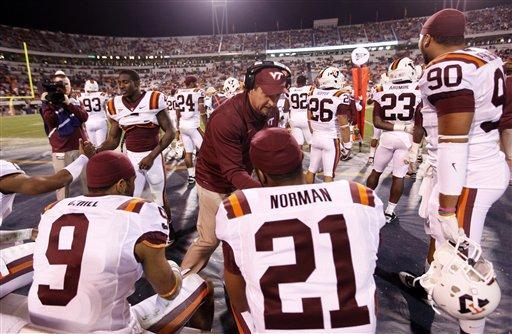 Virginia Tech defensive coordinator Bud Foster, center, congratulates his team in the final minutes of an NCAA college football game against Virginia at Scott Stadium in Charlottesville, Va., Saturday, Nov. 26, 2011. Virginia Tech won the game 38-0.