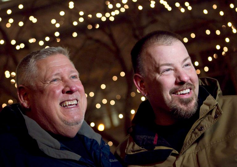   Michael Snell, left, and Steven Bridges speak to a reporter, Friday, Dec. 28, 2012, outside City Hall before obtaining a marriage license under the state's new law in Portland, Maine. Bridges and Snell held a commitment ceremony six years ago but made marriage official under state law with a simple ceremony early Saturday as Maine's new law permitting same-sex marriage took effect at the stroke of midnight. (AP Photo/Robert F. Bukaty)  