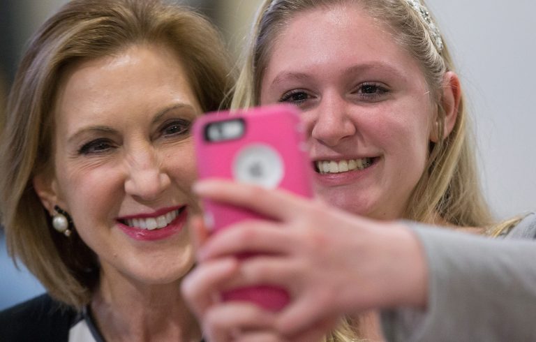 Former business executive Carly Fiorina, left, poses for a selfie with Ashlynn Dale at the Johnson County Republicans Spaghetti Dinner at Clear Creek Amana High School on April 24, 2015 in Tiffin, Iowa. (Getty Image)