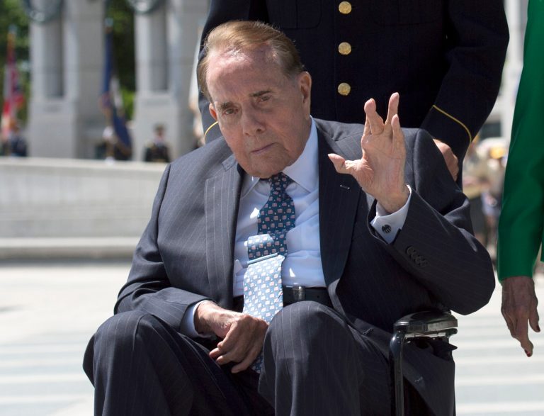FILE - In this May 24, 2014 file photo, WWII veteran and former Senate Majority Leader Bob Dole waves after taking part in a wreath laying ceremony at a 10th anniversary ceremony for the WWII Memorial in Washington. Dole and Republican Sens. John McCain, Kelly Ayotte and Mark Kirk along with Democratic Sen. Tom Harkin met on Wednesday, July 23, 2014, at a Capitol Hill for a news conference to promote an equal rights treaty for the disabled around the world. (AP Photo/Molly Riley, File)