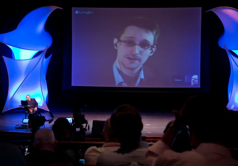 Former NSA contractor Edward Snowden participates in a conversation via video with John Perry Barlow, co-founder & vice chairman of the Electronic Frontier Foundation, at the 2014 Personal Democracy Forum, at New York University, Thursday, June 5, 2014 in New York. (AP Photo/Richard Drew)