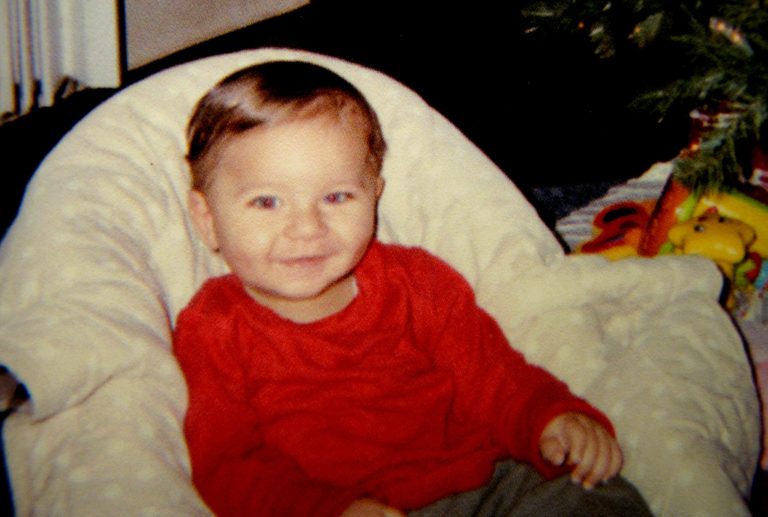 This photo provided Friday, March 22, 2013 by Sherry West, of Brunswick, Ga., shows her son Antonio Santiago celebrating his first Christmas in December of 2012. West says a teenager trying to rob her at gunpoint Thursday asked 