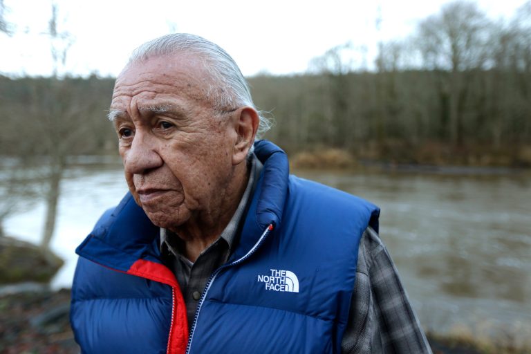 FILE - In this Jan. 13, 2014 file photo, Billy Frank Jr. poses for a photo near Frank's Landing on the Nisqually River in Nisqually, Wash. Frank, a Nisqually tribal elder who was arrested dozens of times while trying to assert his native fishing rights during the Fish Wars of the 1960s and '70s, died Monday, May 5, 2014. He was 83. (AP Photo/Ted S. Warren, File)