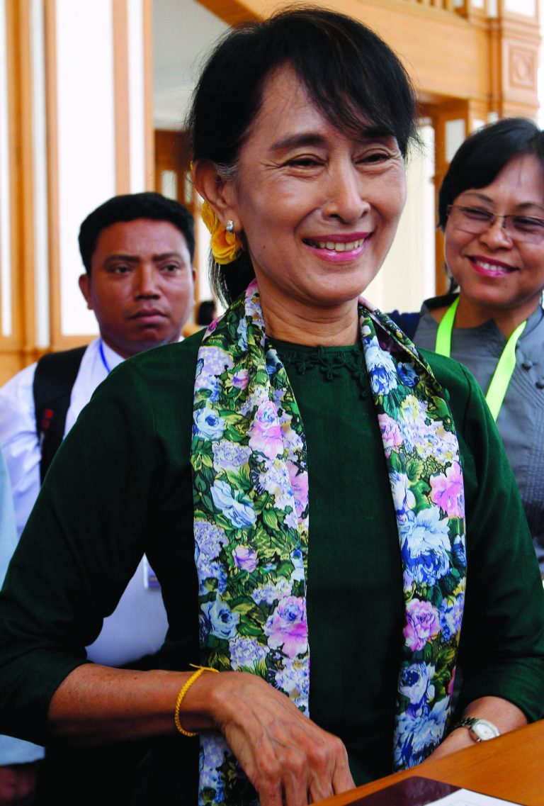 In this July 16, 2012 photo, Myanmar's opposition leader Aung San Suu Kyi arrives to attend a regular session of THE parliament at Myanmar Lower House, in Naypyitaw, Myanmar. Opposition leader Suu Kyi has held her first talks with the president since becoming a member of parliament. A government official says the meeting Sunday, Aug. 12, 2012, with President Thein Sein lasted two hours. (AP Photo/Khin Maung Win)