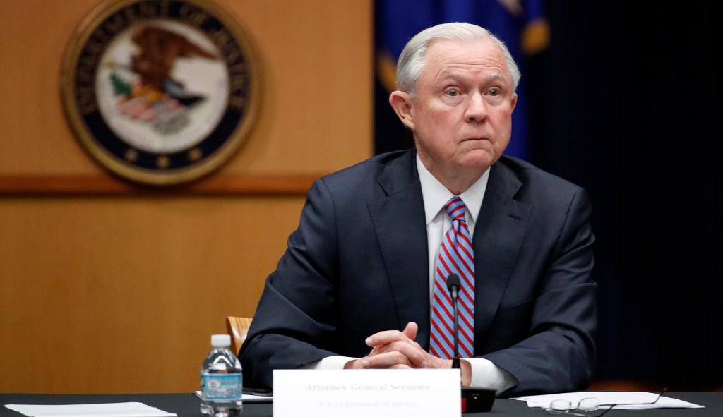 ‘#FireSessions’ projected on Justice Department building