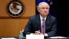 ‘#FireSessions’ projected on Justice Department building