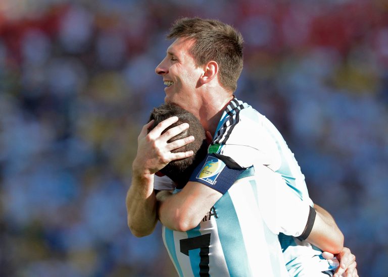 Argentina's Lionel Messi celebrates with Angel di Maria after di Maria scored his side's only and winning goal in extra time during the World Cup round of 16 soccer match between Argentina and Switzerland at the Itaquerao Stadium in Sao Paulo, Brazil, Tuesday, July 1, 2014. Argentina defeated Switzerland 1-0 to move on to the quarterfinals. (AP Photo/Manu Fernandez)