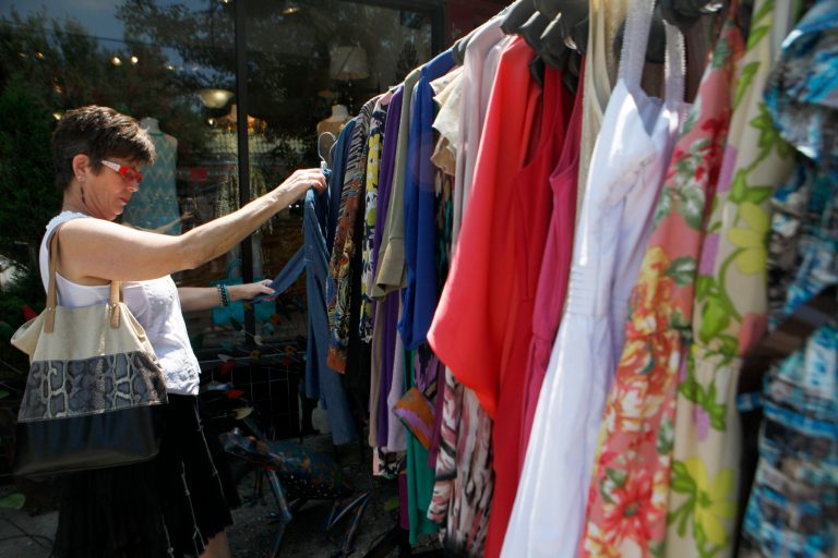   In this Wednesday, June 12, 2013 file photo, Jani McAllister browses through a sales rack outside Festivity, a boutique in Virginia Highlands, in Atlanta. The Federal Reserve reports how much consumers borrowed in June on Wednesday, Aug. 7, 2013. (AP Photo/Jaime Henry-White)  