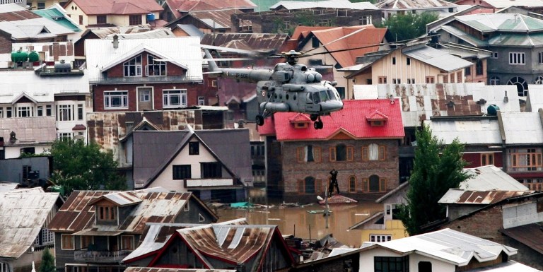 In this photograph released by the Indian government's Ministry of Defense, a civilian is airlifted into an Indian air force chopper in Srinagar, Indian-controlled Kashmir, Wednesday, Sept. 10, 2014. Raging monsoon floods sweeping across India and Pakistan have killed more than 450 people, authorities said Tuesday, warning hundreds of thousands more to be prepared to flee their homes as helicopters and boats raced to save marooned victims. (AP Photo/Ministry of Defense)