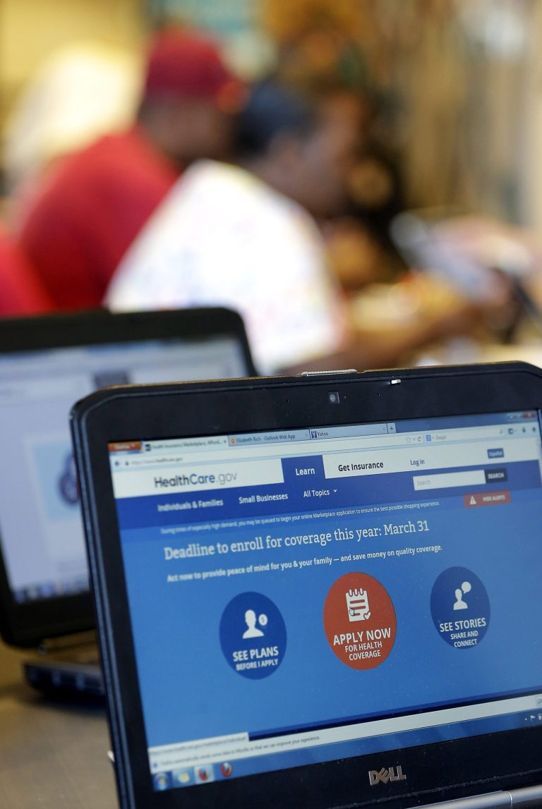 FILE - In this March 31, 2014 file photo, people sign up for the Affordable Care Act at Swope Health Services, in Kansas City, Mo. The Associated Press interviewed insurance agents, health counselors and attorneys around the country who said they received varying subsidy amounts for the same consumers. (AP Photo/Charlie Riedel, File)