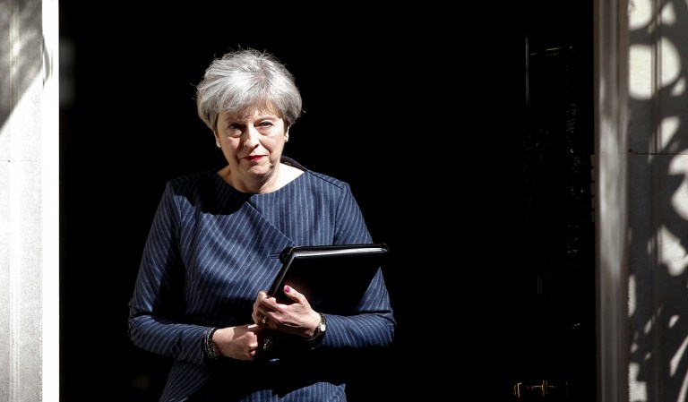 Britain's Prime Minister Theresa May walks out of 10 Downing Street to speak to the media in London on Tuesday, April 18, 2017. May announced she will seek early election on June 8. (AP Photo/Alastair Grant)
