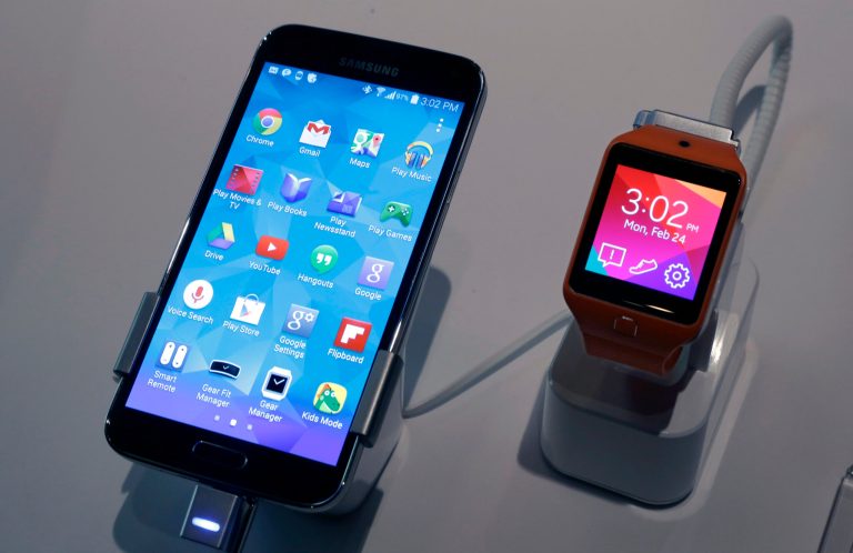 A Samsung Galaxy S5 smartphone, left,  and a Samsung Gear 2 are displayed at the Samsung Galaxy Studio, in New York,  Monday, Feb. 24, 2014. Samsung on Monday unveiled a new smartphone with a built-in heart rate monitor to complement three upcoming fitness devices, as the Korean company tries to turn its technological wizardry into lifestyle products. (AP Photo/Richard Drew)