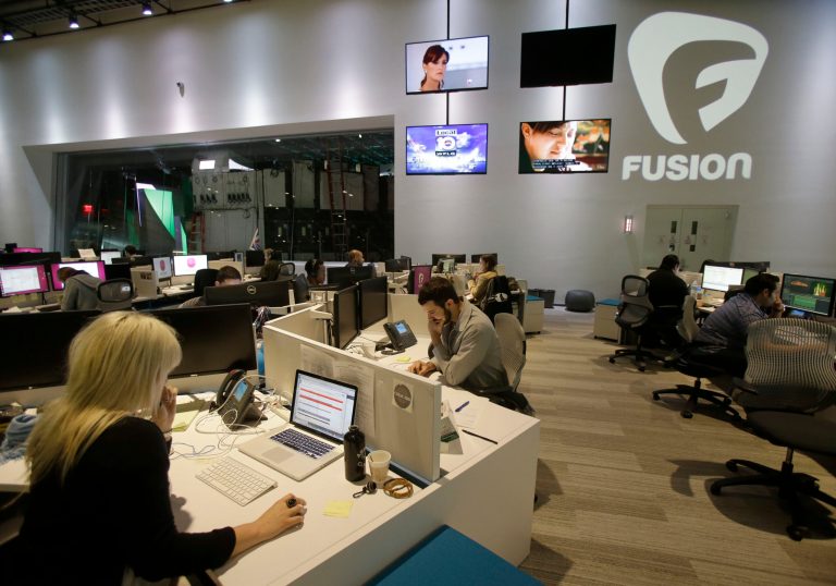 Workers are shown in the Fusion network's warehouse-turned-news hub known as Newsport, in Doral, Fla. The English-language television network is targeting millennial Hispanics. The network's mix of news, commentary, sports and irreverence is aimed at a generation for which cultural fusion is the norm, and digital media is king. (AP Photo/Wilfredo Lee)