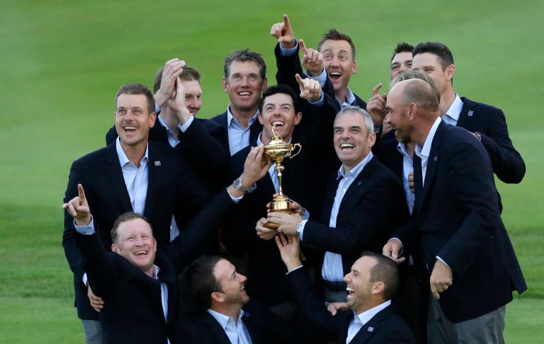 Europe team captain Paul McGinley, center right, and his team  hold the trophy after winning the 2014 Ryder Cup golf tournament at Gleneagles, Scotland, Sunday, Sept. 28, 2014. (AP Photo/Matt Dunham)