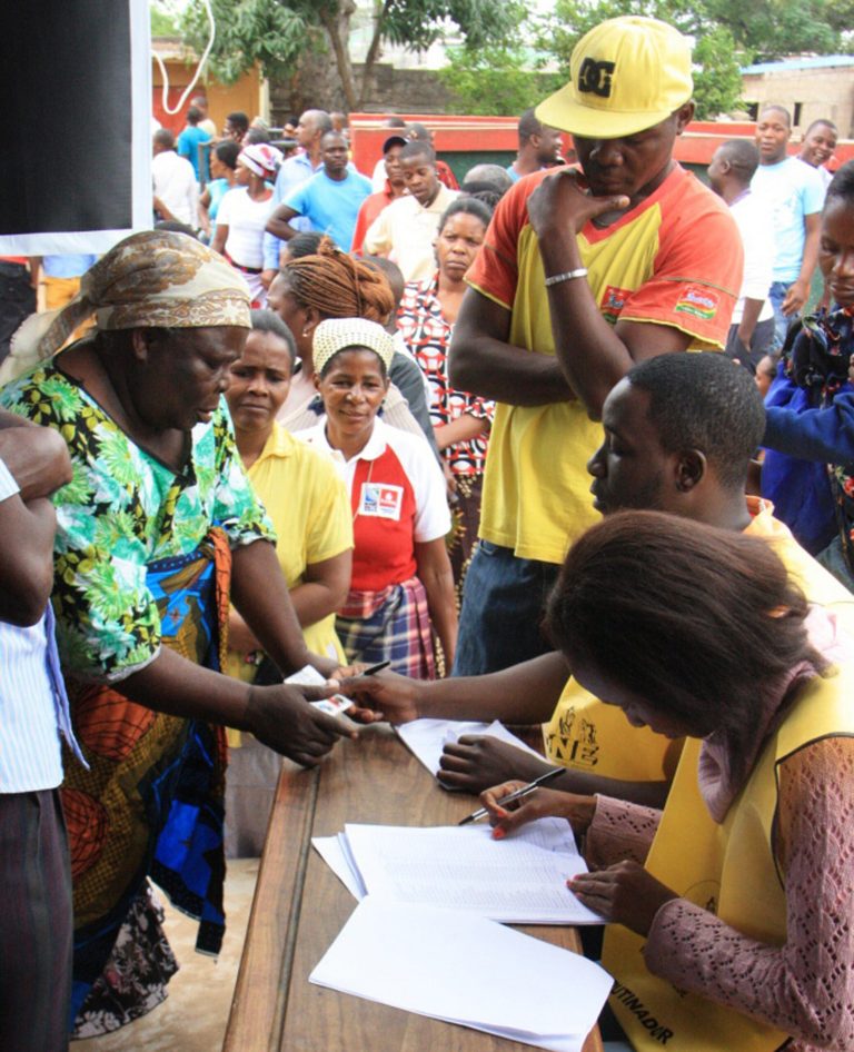 Voters produce identity documents as they go through the voting process at a polling station, in Maputo, Mozambique, Wednesday, Oct. 15, 2014. Voting in Mozambique's national election began peacefully Wednesday. The election comes just months after a peace accord between the ruling Frelimo party and the opposition, Renamo, ended nearly two years of sporadic fighting in the north of the country. (AP Photo/Ferhat Momade)