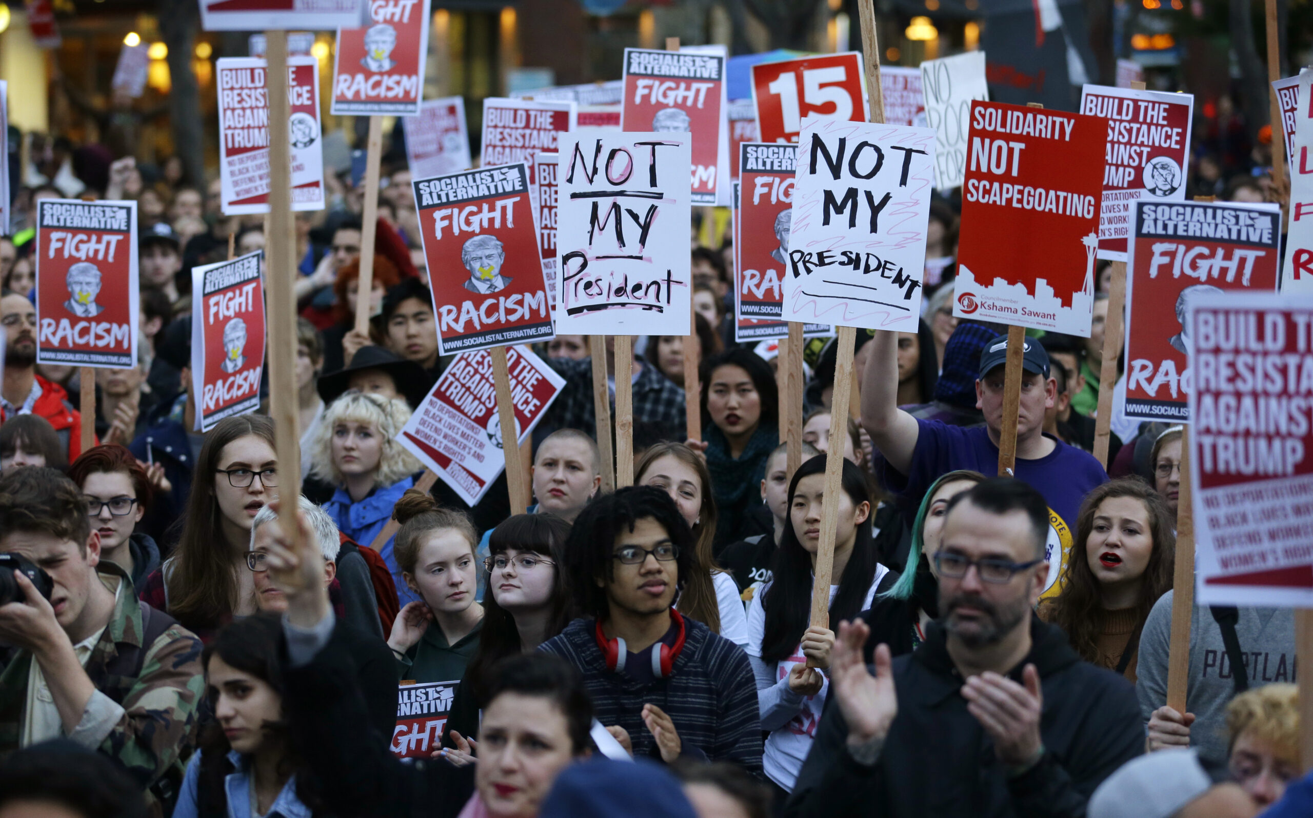 Thousands flood streets to protest Trump in seven cities