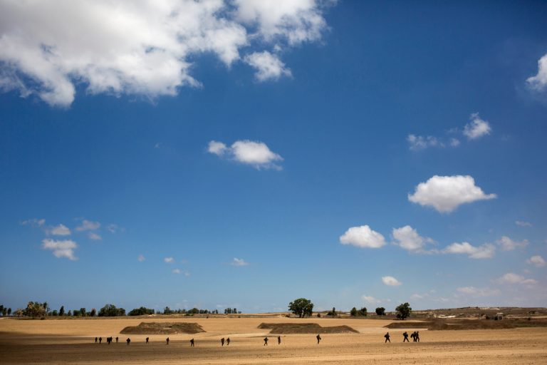 Israeli soldiers patrol near the Israeli and Gaza border, Friday, July, 18, 2014. Israeli troops pushed deeper into Gaza on Friday to destroy rocket launching sites and tunnels, firing volleys of tank shells and clashing with Palestinian fighters in a high-stakes ground offensive meant to weaken the enclave's Hamas rulers. Israel launched the operation late Thursday, following a 10-day campaign of more than 2,000 air strikes against Gaza that had failed to halt relentless Hamas rocket fire on Israeli cities. (AP Photo/Dusan Vranic)