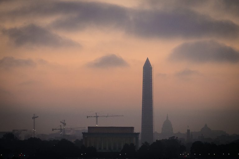 Low clouds and fog roll across Washington at sunrise Tuesday as Congress continues to negotiate their way free from the budget standoff that has shutdown many parts of the U.S. government for 15 days. (AP/J. David Ake)