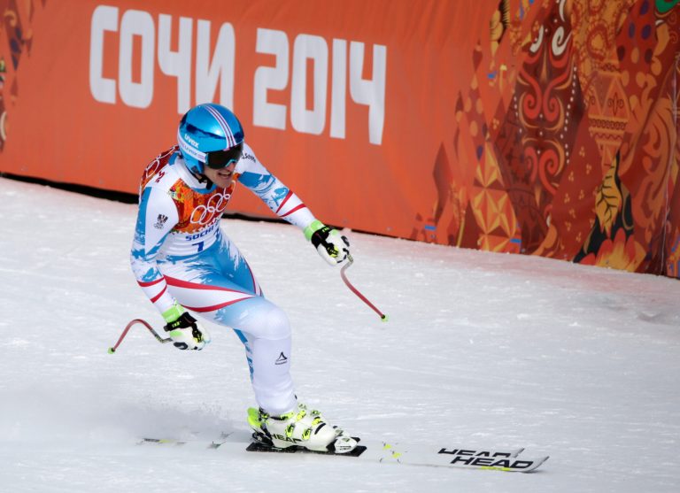 Austria's Matthias Mayer finishes to win the gold in the men's downhill at the Sochi 2014 Winter Olympics, Sunday, Feb. 9, 2014, in Krasnaya Polyana, Russia. (AP Photo/Gero Breloer)