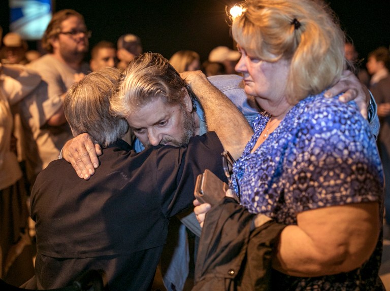 Texas Gov. Greg Abbott consoles Ted and Ann Montgomery, members of the First Baptist Church in Sutherland Springs, at a vigil for the victims of mass shooting at the church, Sunday, Nov. 5, 2017, in Sutherland Springs, Texas. (Jay Janner/Austin American-Statesman via AP)