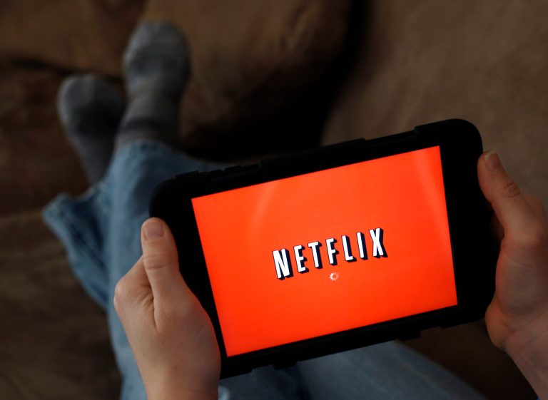FILE - In this Friday, Jan. 17, 2014 file photo, a person displays Netflix on a tablet in North Andover, Mass. Netflix is raising its Internet video prices by $1 per month for new customers and giving its current U.S. subscribers a two-year break from the higher rates. (AP Photo/Elise Amendola, File)