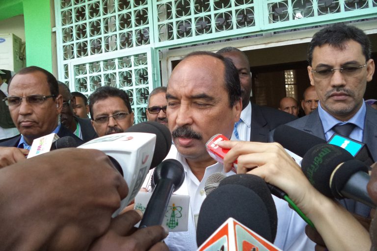 Mauritania's President Mohamed Ould Abdel Aziz, center, speaks with media after he cast his ballot during elections held in the city of  Nouakchott , Mauritania, Saturday, June 21, 2014. Mauritanians voted Saturday to choose their next president, but with the major opposition parties boycotting, the incumbent seems certain to hold on to power. Mohamed Ould Abdel Aziz, who assumed power in a coup in 2008 and won elections a year later, has been a staunch ally of the West in facing the growing terror threat in West Africa.(AP Photo/Ahmed Mohamed)