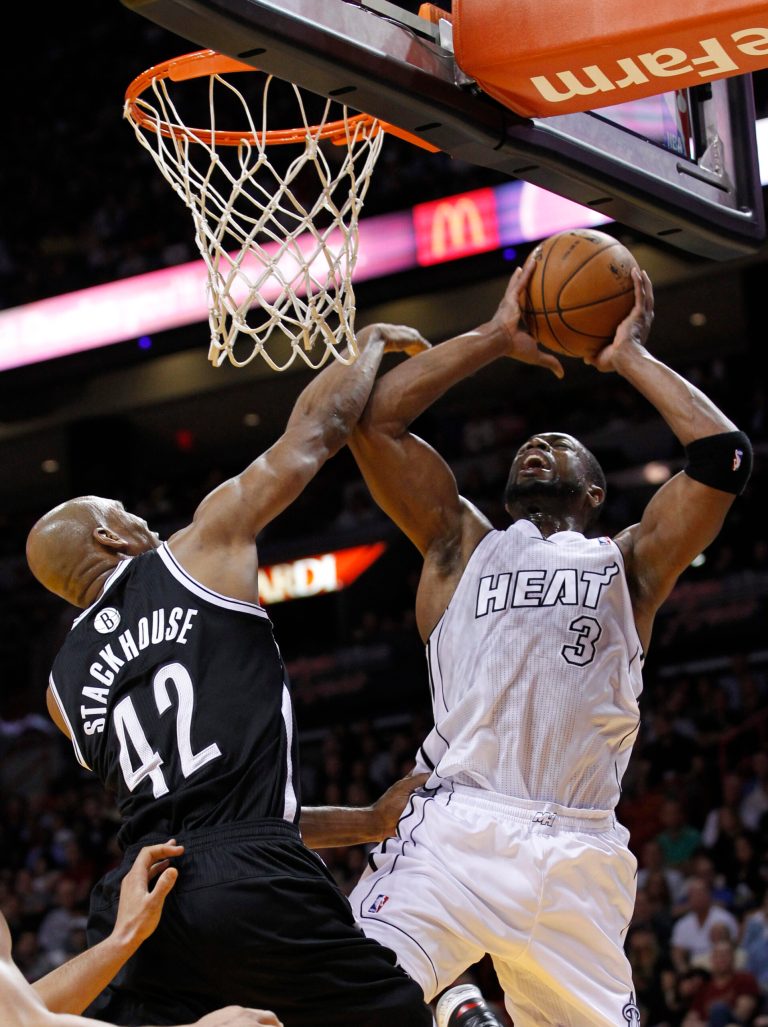   Miami Heat guard Dwyane Wade (3) goes up for a shot against Brooklyn Nets forward Jerry Stackhouse (42) during the first half of an NBA basketball game, Saturday, Dec. 1, 2012 in Miami. (AP Photo/Wilfredo Lee)  
