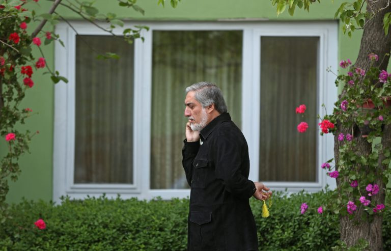 Afghan presidential candidate Abdullah Abdullah talks on the phone before an interview with The Associated Press at his residence in Kabul, Afghanistan, Sunday, April 20, 2014. New partial results released in Afghanistan's presidential election show candidate Abdullah Abdullah is still the front-runner, though a runoff election looks likely. The winner will replace Hamid Karzai, the only president the country has known since the 2001 U.S.-led invasion ousted the Taliban, and will oversee a tumultuous period during which the U.S. and NATO forces are expected to withdraw most of their troops from the country. (AP Photo/Massoud Hossaini)