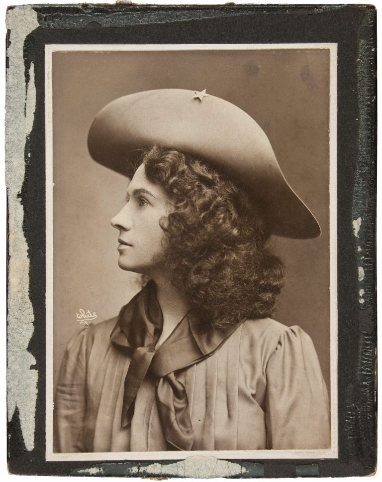   This handout photo, provided by Heritage Auctions, shows Annie Oakley in one of her cabinet photos. Oakley wears the dark wig she wore for The Western Girl was taken in New York between 1902 and 1904. Relatives of Oakley are selling items that once belonged to the legendary sharpshooter including a Stetson hat, guns, letters and photographs. Heritage Auctions will offer up about 100 items related to Oakley on Sunday in Dallas.(AP Photo/Courtesy of Heritage Auctions)  
