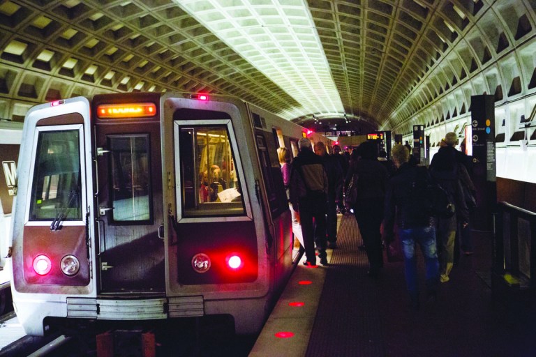 Commuters board a train at Farragut North Metro station, Monday, October 10, 2012