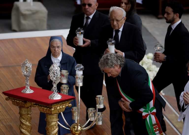 The relics of Pope John Paul II and Pope John XXIII are brought to the altar during a solemn ceremony in St. Peter's Square at the Vatican, Sunday, April 27, 2014. Pope Francis has declared his two predecessors John XXIII and John Paul II saints in an unprecedented canonization ceremony made even more historic by the presence of retired Pope Benedict XVI.  (AP Photo/Gregorio Borgia)