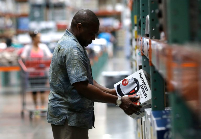 In this June 4, 2014 photo, a shopper checks out an item for sale at a Costco in Plano, Texas. The University of Michigan issues its index of consumer sentiment for August 2014 on Friday, Aug. 29, 2014. (AP Photo/LM Otero)