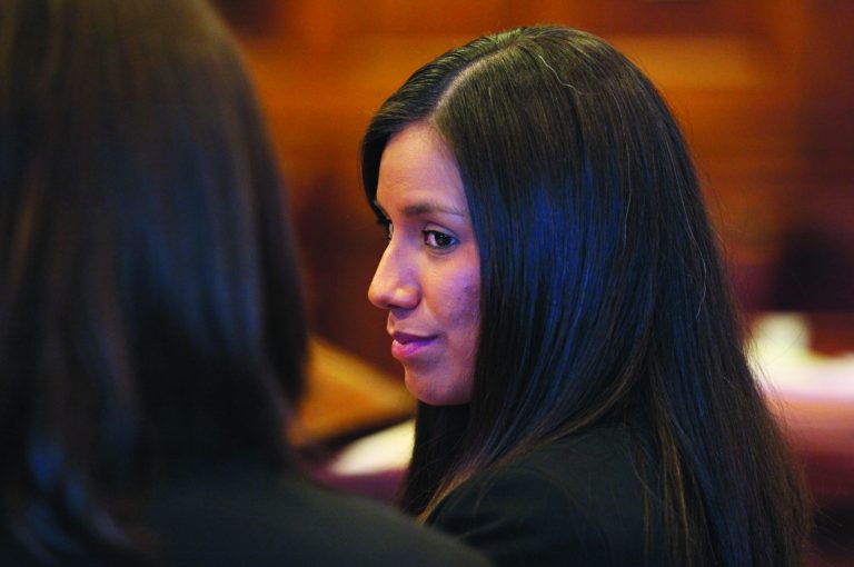 FILE - In this Oct. 9, 2012 file photo, Alexis Wright, 29, turns towards her attorney Sarah Churchill, left, during her arraignment in Portland, Maine. Maine's highest court is preparing to weigh in on whether prostitution johns who were recorded without their knowledge have a right to privacy. A trial judge dismissed 46 invasion of privacy counts against Mark Strong Sr., who's accused of viewing sex videos featuring men who were unaware that they were being recorded with Alexis Wright who's accused of using her Zumba studio as a front for prostitution. (AP Photo/Joel Page, File)