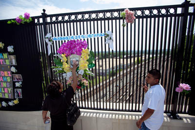 Candida Carver, left, the aunt of Ana Fernandez -- who was killed in the Fort Totten Metro crash -- and Ana's son Antonio, right, stands on a bridge overlooking the site of the crash on the two-year anniversary in June 2011. (Examiner file photo)