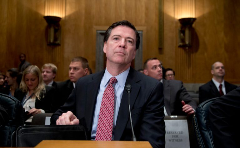 FBI Director James Comey takes his seat on Capitol Hill in Washington, Thursday, Nov. 14, 2013, prior to testifying before the Senate Homeland Security and Governmental Affairs Committee hearing to examine threats to the homeland. (AP Photo/Carolyn Kaster)